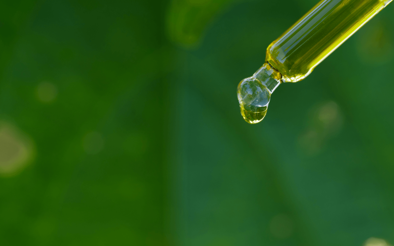 Close-up of Nunaia's nurishing radiance organic serum drops coming out of dropper