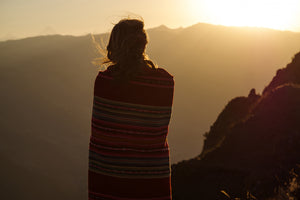 Peaceful shot of woman up the Andes Mountains reflecting and finding greater inner balance and well-being